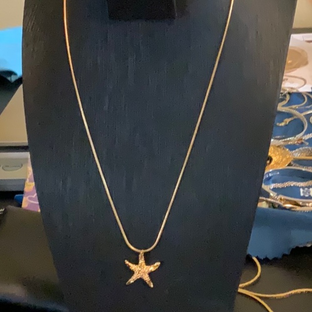 Gold tone starfish pendant.